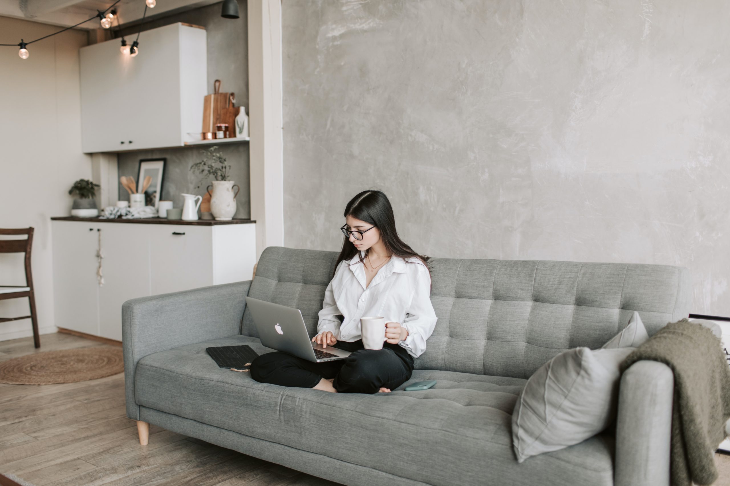 Woman doing virtual onboarding while sitting on couch
