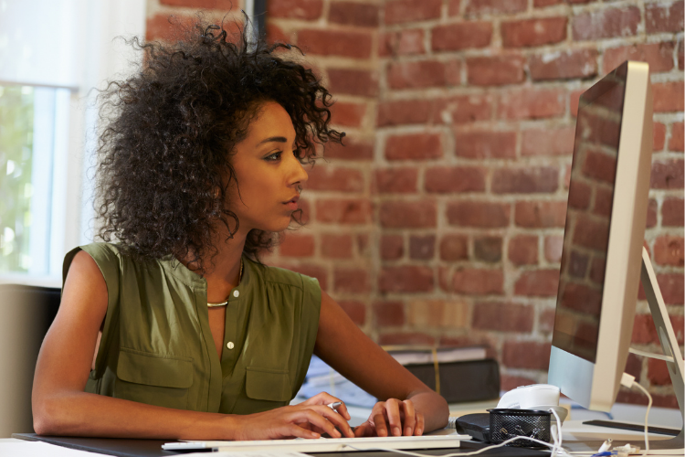 Woman in office working on desktop computer