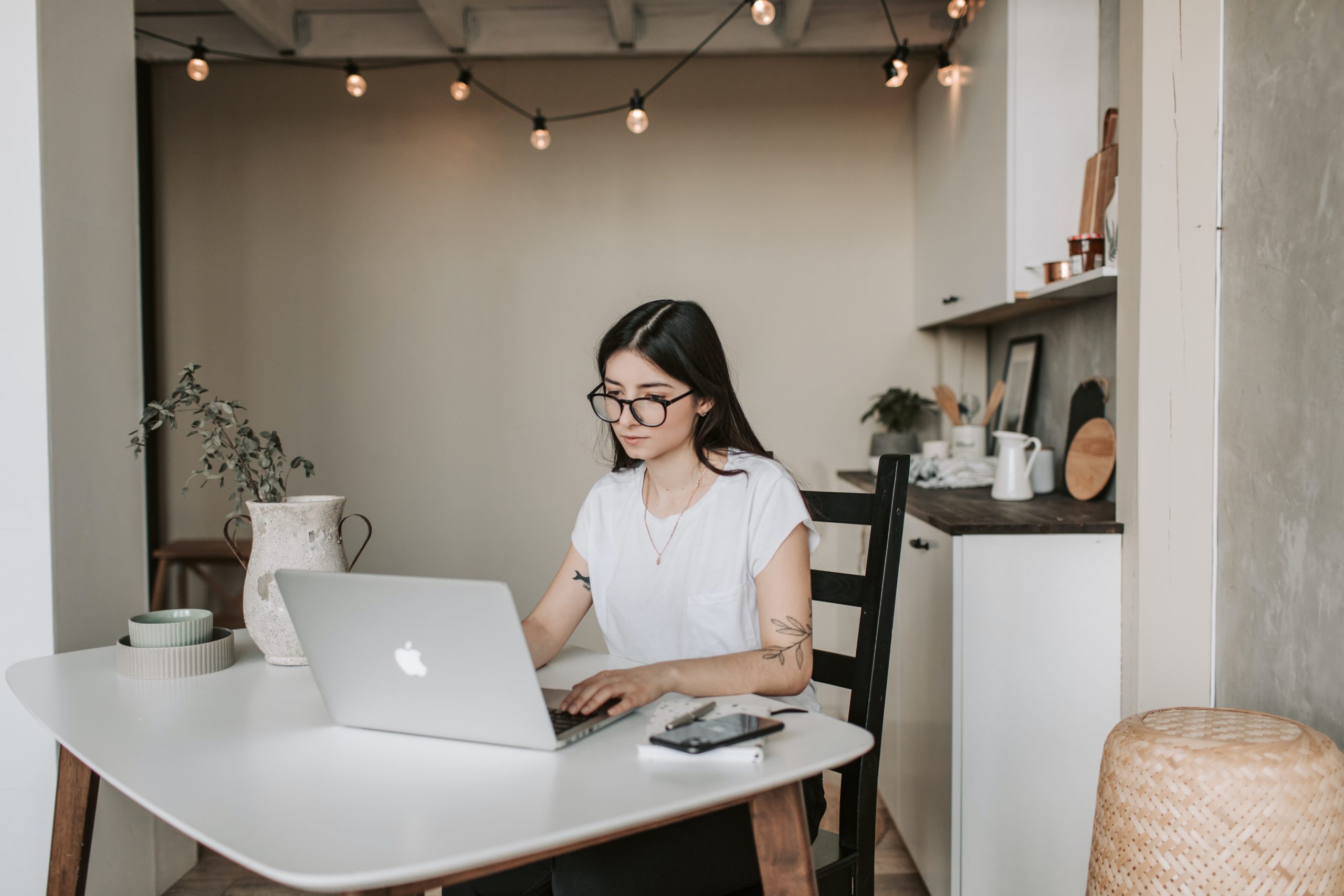 Young woman on MacBook working from home