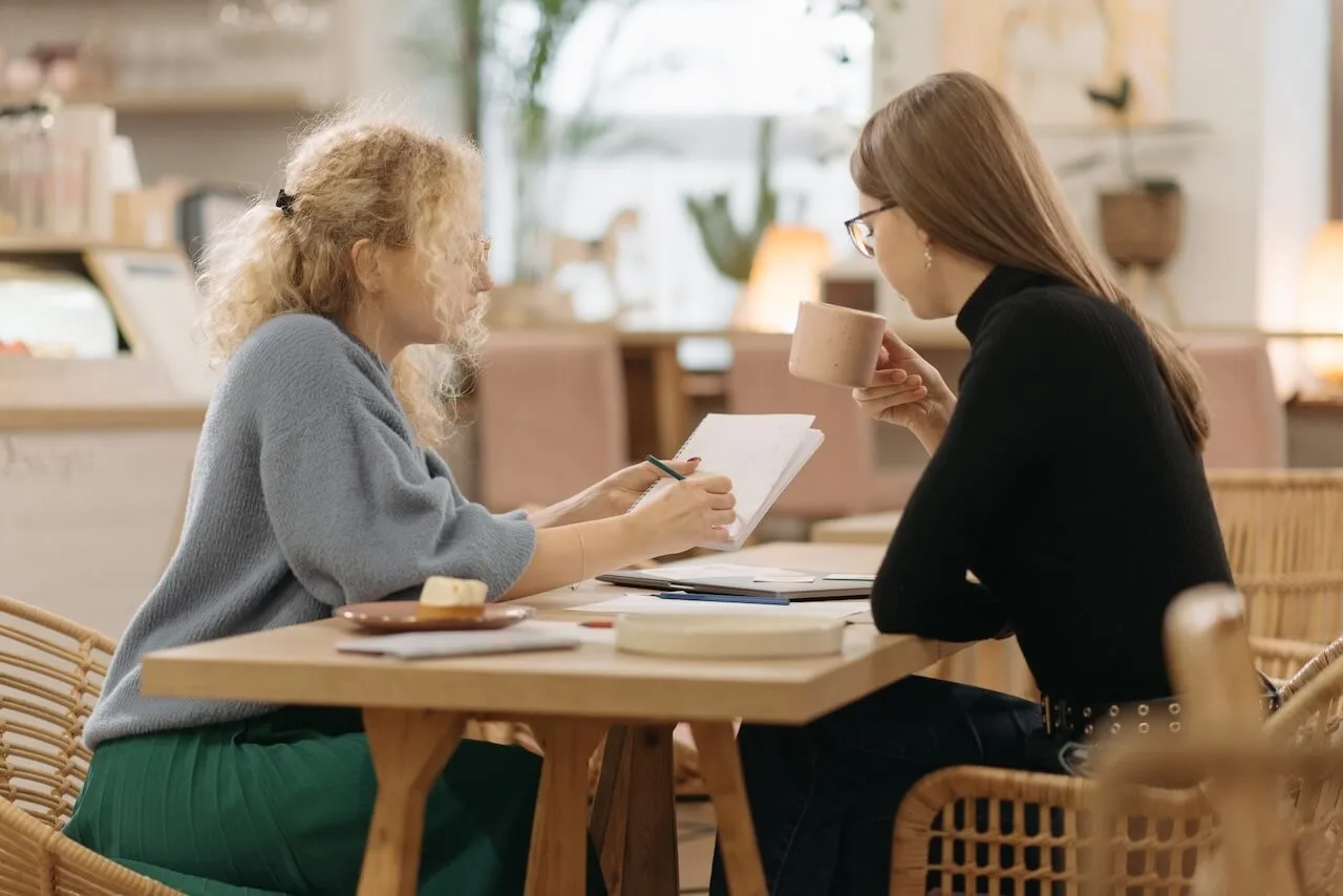 Two women colleagues doing quarterly performance review