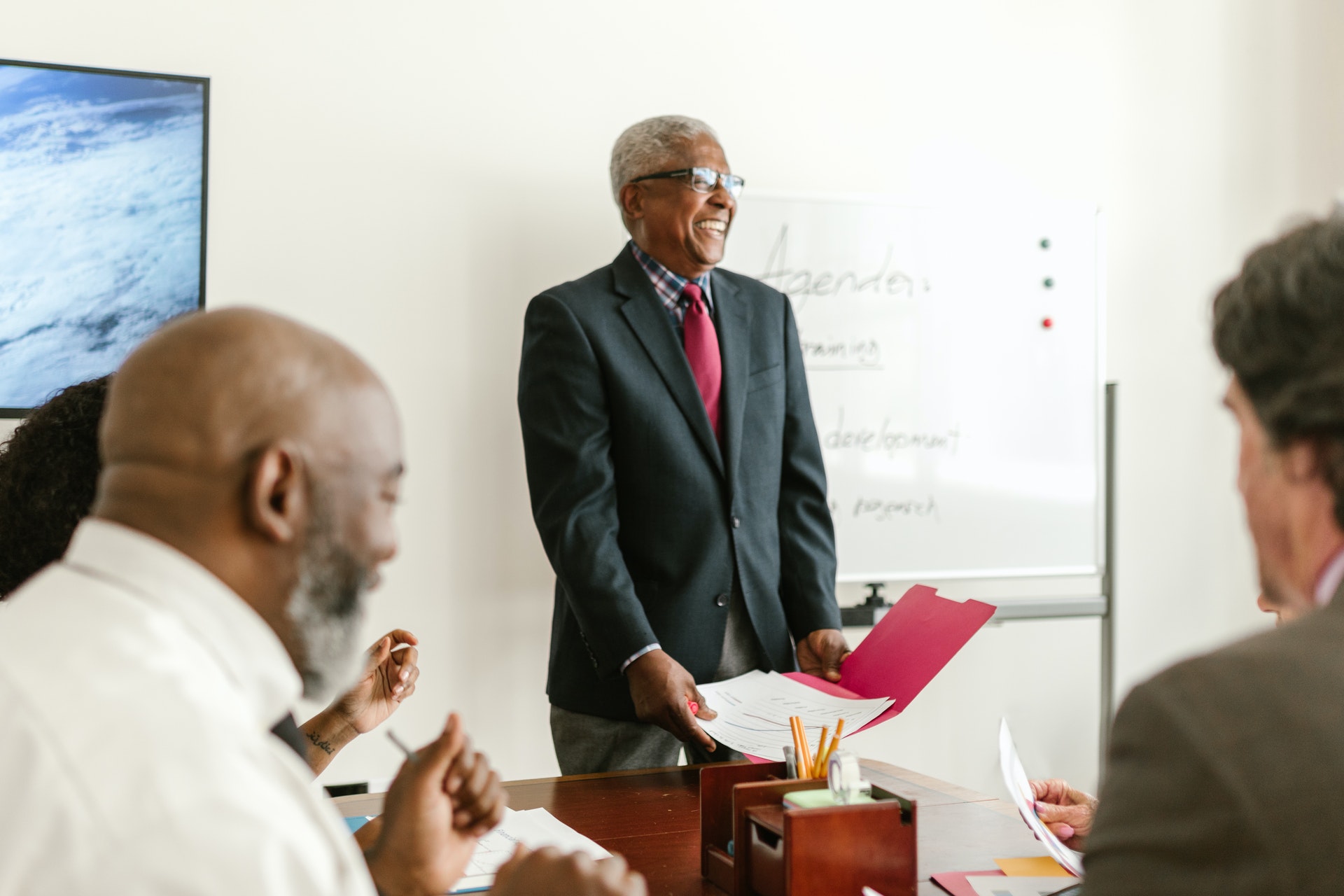 Professional Black man and colleagues doing a project review