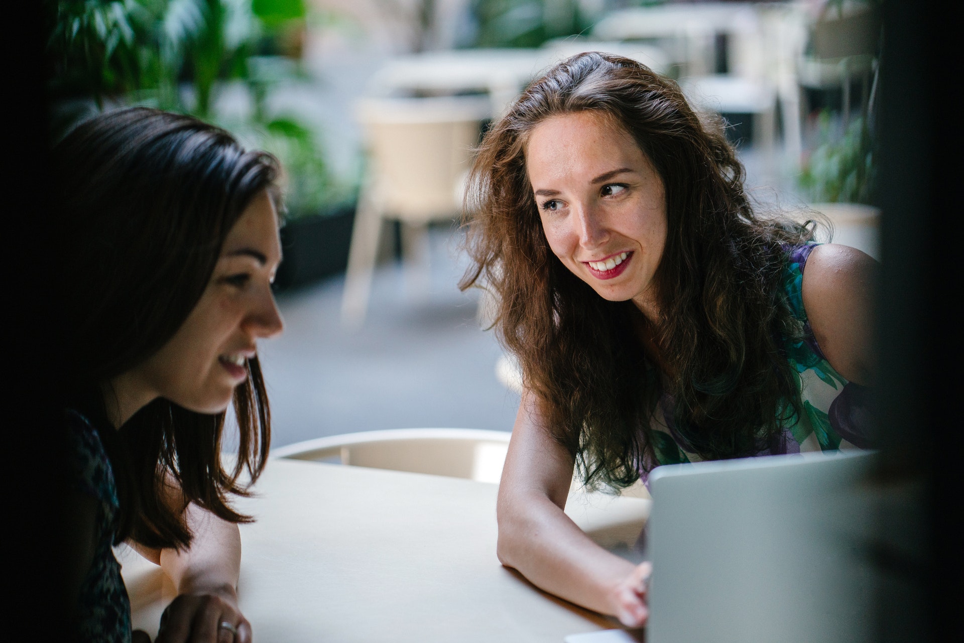Two women looking at a performance rating scale on a laptop