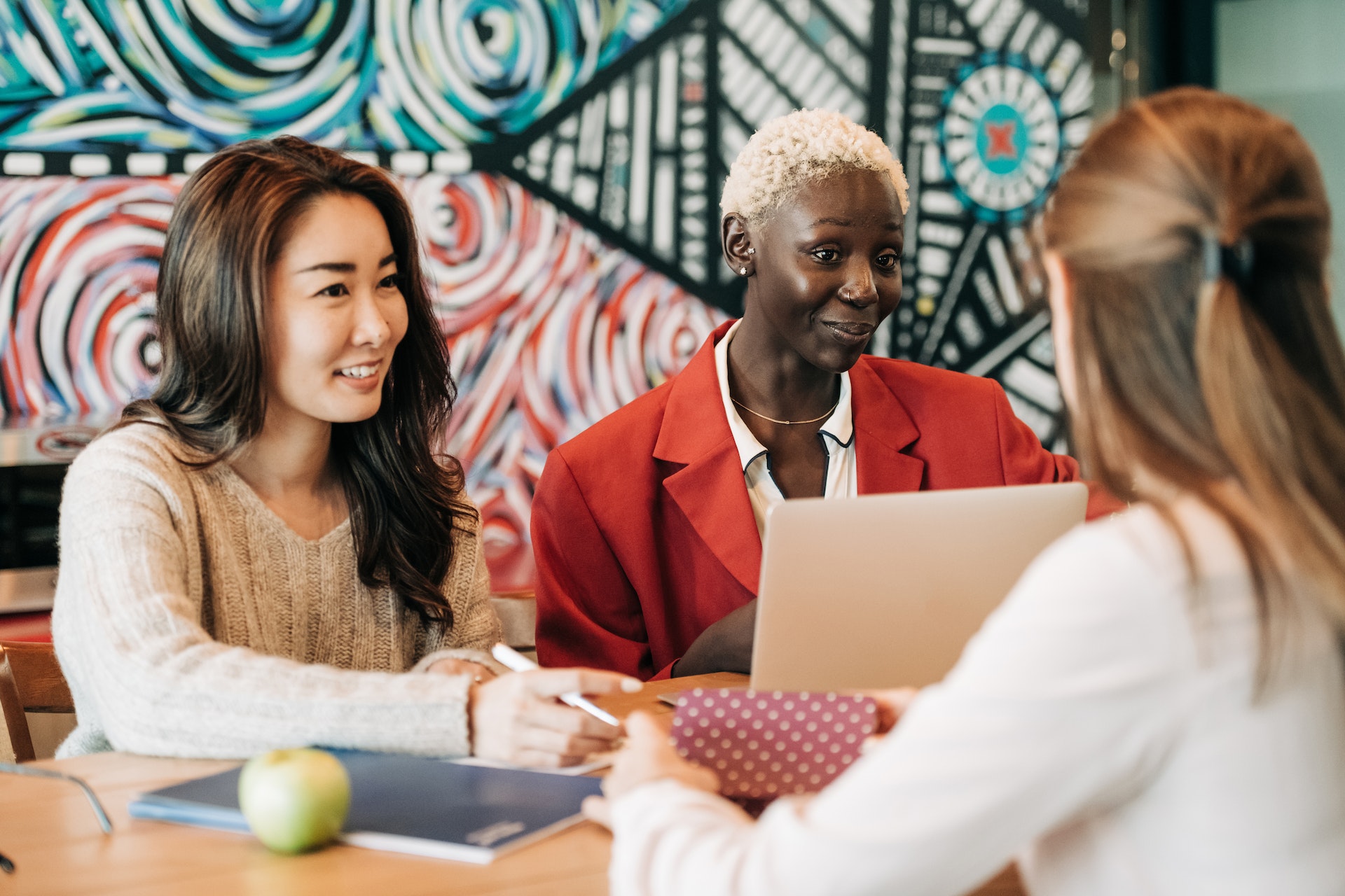 Three women high performers in casual work meeting