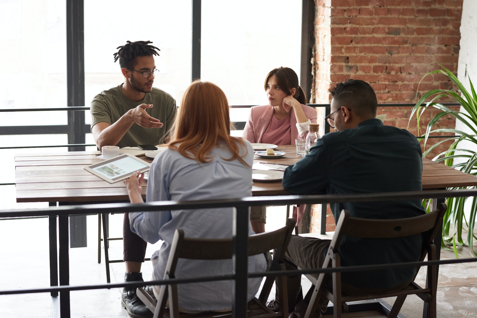 Group of colleagues sitting discussing performance management tools