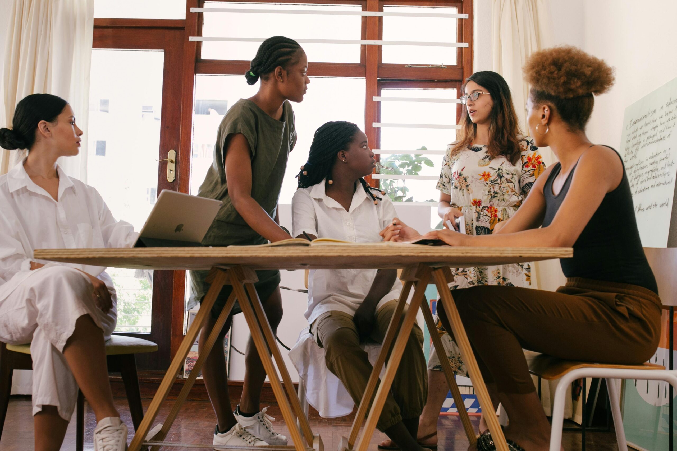 a-group-of-people-sitting-at-the-table-at-a-business-meeting HR managers discussing the impact of the big 5 on work relationships